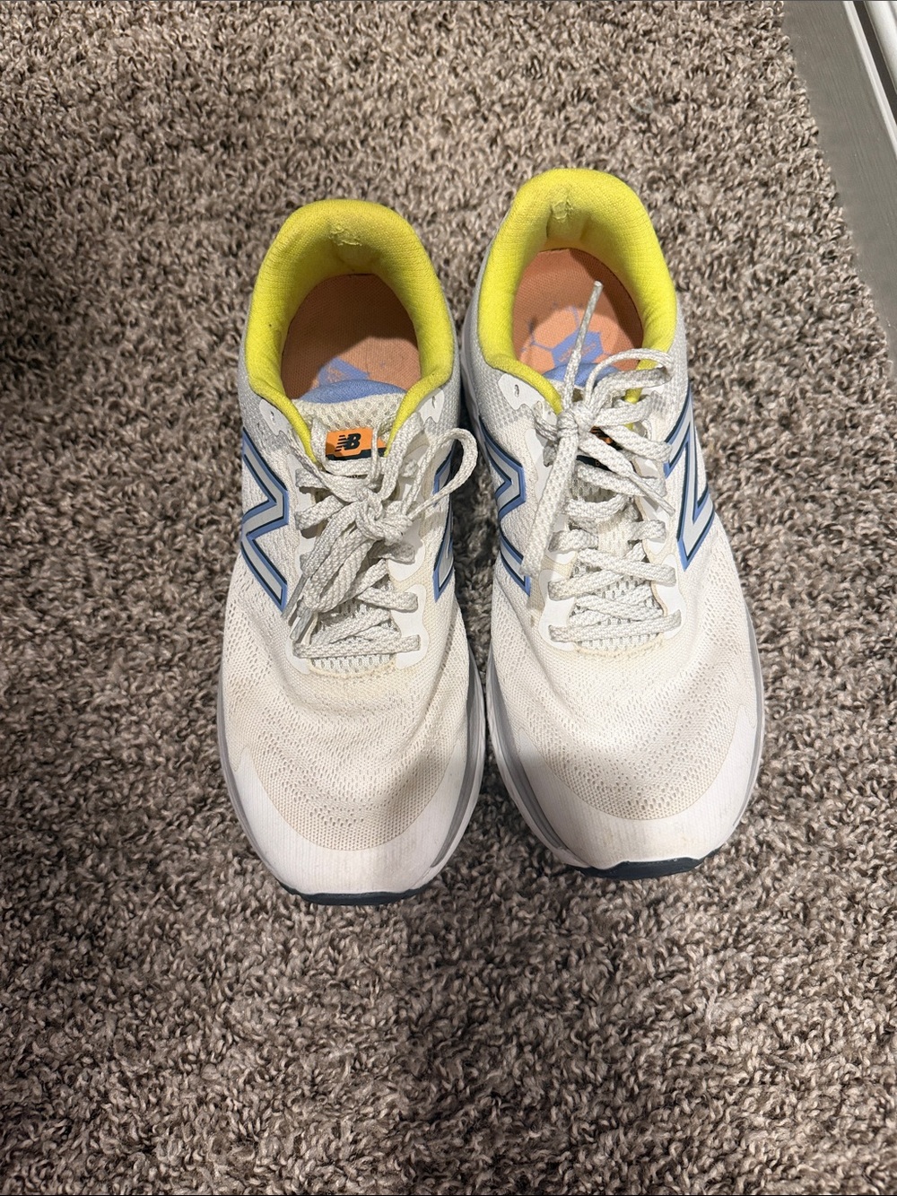 New Balance White Sneakers with Blue Logos and Yellow Linings